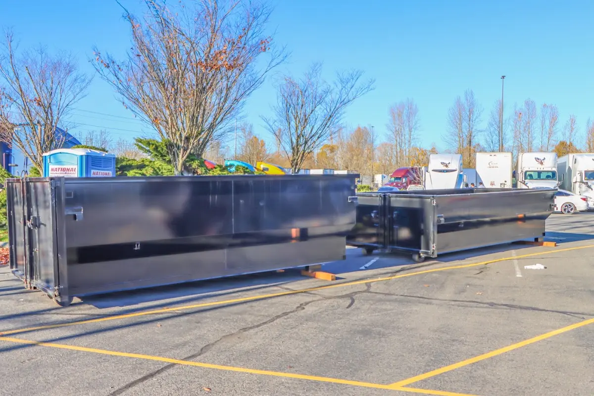 Professional dumpster rental service with roll-off container on residential driveway in Griffin